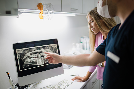 Doctor from Downey Oral and Maxillofacial Surgery looking at digital x-ray in Downey, CA